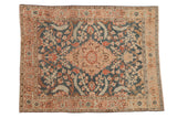 Vintage distressed Tabriz rug with a central medallion, scrolled leaves, and terracotta blossoms on a dusty teal field.
