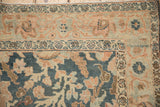 A distressed Tabriz rug corner showing the Samovar Turtle motif and abrashes in teal and terracotta.