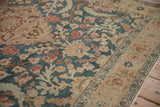 Close-up of the vintage Tabriz rug's low pile, showing its turtle design border and floral motifs.