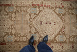 Antique Caucasian runner with geometric medallion and storied wear in coffee brown and powder blue.