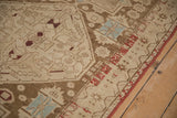 Distressed geometric patterns on antique Caucasian rug with coffee brown and brick red.