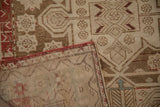 Corner of distressed Caucasian rug, showing worn geometric pile and hand-woven foundation.