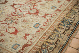 Vintage Bibikabad carpet detail: copper and blue blossoms with visible abrashes, ornate gold border.