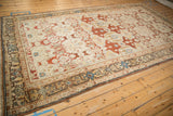 Intricate geometric border of the vintage Bibikabad carpet in beige, rust, and blue.