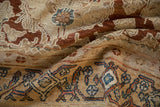 Close-up of vintage Bibikabad carpet border with stylized blue and copper motifs on a sand ground.