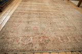 Distressed antique Persian Kerman border, terracotta, sage green, and ivory Safavid-style motifs.