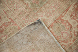Distressed Antique Kerman rug showing faded floral motifs and woven foundation.