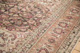 Low pile texture and time-softened colors on the Herati field and raspberry border.