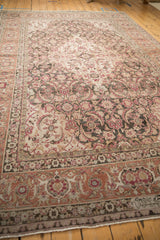 Weaver's inscription within the raspberry red and silver floral border of a vintage Persian Tabriz rug.
