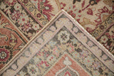 A vintage Tabriz carpet corner folded to show the hand-knotted foundation and secured side selvage.