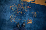 A pictorial hanging lantern and scrolled vine motif on an antique Peking carpet.