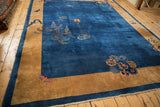 Perspective view of an antique Peking carpet, showcasing its open cobalt field and wide golden border.