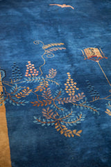 Scrolled vine, hanging lantern, and bat motif on a cobalt blue antique Peking carpet.