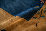 Rich cobalt blue and warm gold hues in the dense, plush pile of an antique rug.