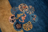 Floral medallion detail on a Peking rug with gold, dusty rose, and cobalt blue motifs.