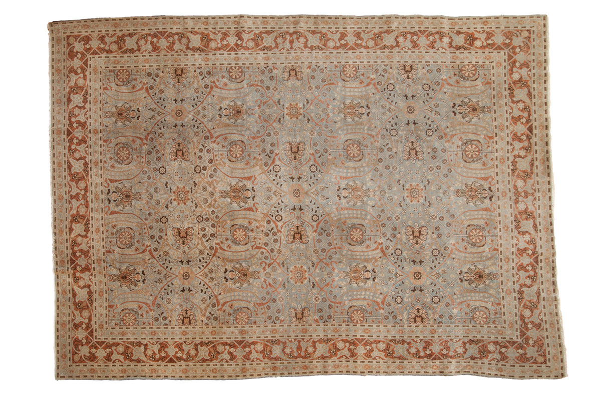 Distressed vintage Tabriz carpet, dusty slate blue field with copper scrolling florals and trellis vinery. 9' x 12'5".