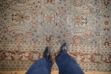 Distressed Tabriz rug with faded slate blue field and scrolling floral vinery.