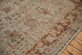 Distressed Tabriz carpet detail: pale blue, copper floral vinery, faint foundation through low pile.