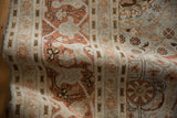 Distressed vintage Tabriz rug with worn pile, pale copper, dusty blue floral design.