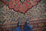 Perspective view of the low-pile texture and dense Herati pattern on an antique Halvaie Bijar carpet.