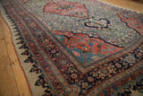Dragon-style arabesques in the corner spandrels and dense Herati field of an antique Persian Bijar carpet.