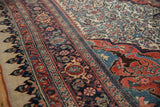 Intricate dragon-style arabesques in the red and blue corner spandrel of an antique Bijar carpet.