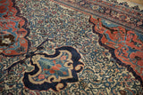 Detailed view of dragon-style arabesques meeting the ivory Herati field on an antique Halvaie Bijar carpet.