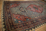 Angled perspective on a late 19th-century Bijar carpet, detailing the spandrel and medallion arabesques.