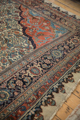An antique Halvaie Bijar corner, displaying the complex floral borders and traditional Herati field.