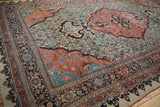 Perspective of an antique Bijar carpet's covered Herati field and shield-like medallion.