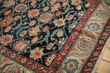 Antique Northwest Persian runner detail: navy floral top views, geometric vines, and red border.