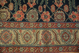 Antique runner border featuring beige geometric medallions, red bands, and a navy floral field.