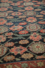 Antique Northwest Persian runner: blush floral top views, dusty teal vines on navy field.