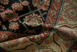 Northwest Persian runner's folded detail, showing navy floral motifs, madder red, and even pile wear.
