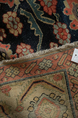 Antique Northwest Persian runner, madder red border, navy floral field, even wear.