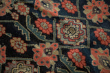 Hand-knotted antique Persian runner detail: navy field, madder root red floral top views, dusty teal vines.