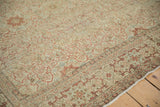 Distressed antique Tabriz carpet showcasing intricate terracotta vines, powder blue accents, and visible even wear.