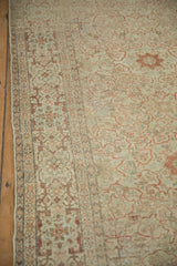 Antique Distressed Tabriz carpet border displaying meandering vines and field's faded terracotta motifs with visible wear.