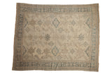 Vintage distressed Oushak carpet with stylized guls in a soft palette of pale green, silver, and beige.