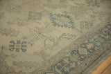 Angled view of the Oushak's low pile, stylized guls, and pale slate blue border.