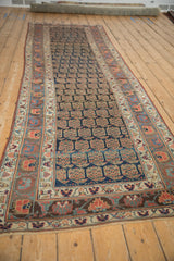 Unusual aubergine floral border and repeating boteh pattern on this antique Kurdish runner.