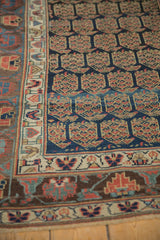 Aged texture on antique Kurdish runner's navy boteh, ivory geometric, and aubergine borders.