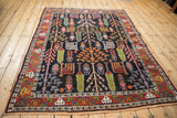 Hand-knotted Bakhtiari rug corner with madder root red border, germinating plant fills, and fringe.