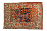 Antique Malayer sampler rug showcasing a patchwork of traditional Persian motifs in navy blue, tangerine, and red.