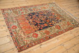 The unique compilation of patterns on an antique Malayer sampler rug, viewed from an angle.