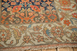 Contrasting floral and geometric borders meet on this antique hand-knotted Malayer sampler rug.