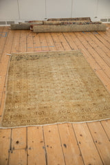 Antique Persian Tabriz rug with a soft, distressed patina, showing its allover design in muted bronze tones.