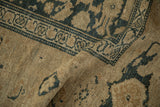 Distressed pile worn to the knot heads on a sand and navy blue antique Kurdish rug.