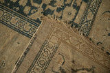 Corner of an antique Kurdish rug folded to show the hand-knotted pile and woven foundation.