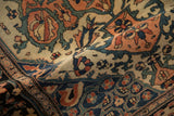 Detailed view of palmettes and meandering vines on an antique Farahan Sarouk rug's low pile.